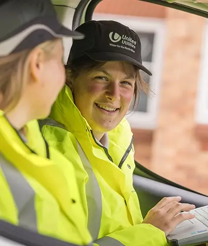 Two staff members working in a vehicle