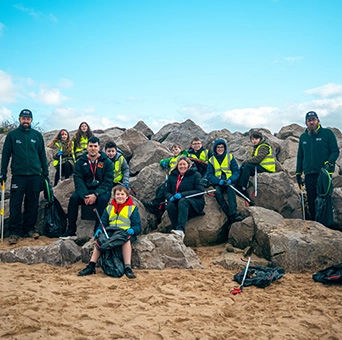 colleagues helping community by litter picking